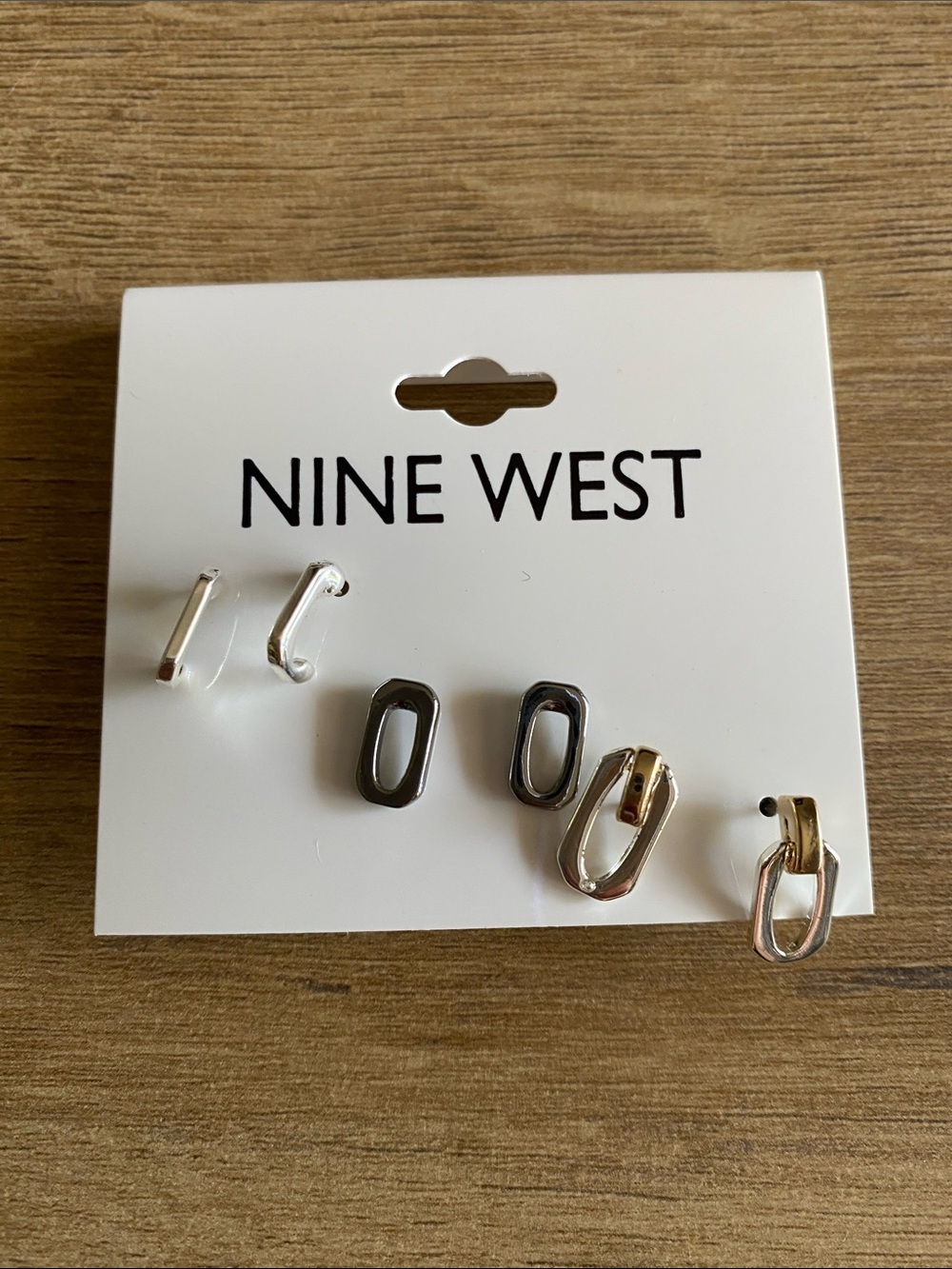 Nine West three pairs of different colored metals earrings